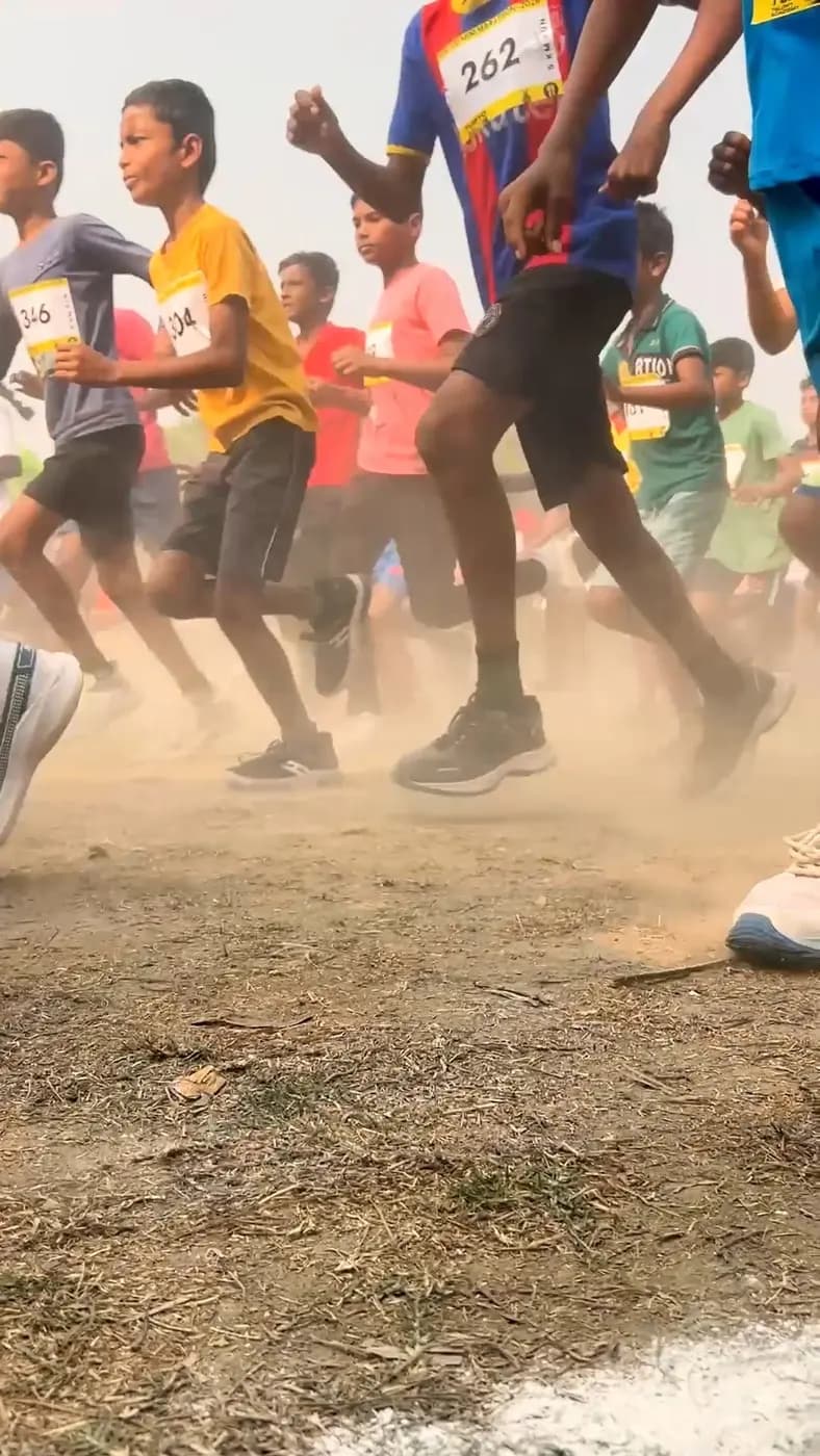 Runners’ feet kick up dust on the dry ground during the race