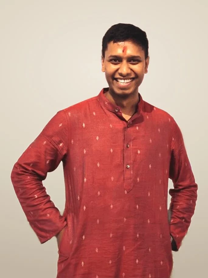 Shimul Sarkar, curator of the Gohona Bori residency, smiling, in a maroon kurta