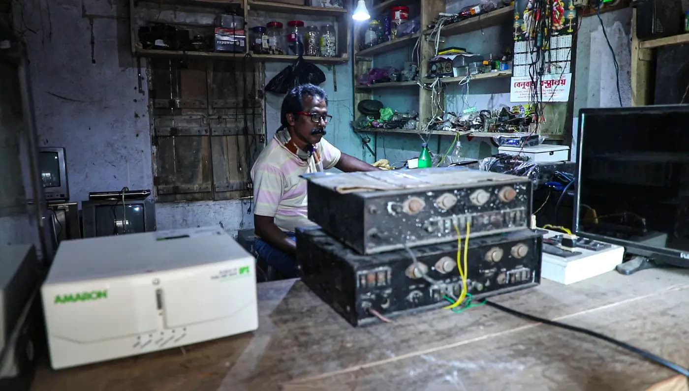 Local DJ box maker behind amplifier units in his electronics shop