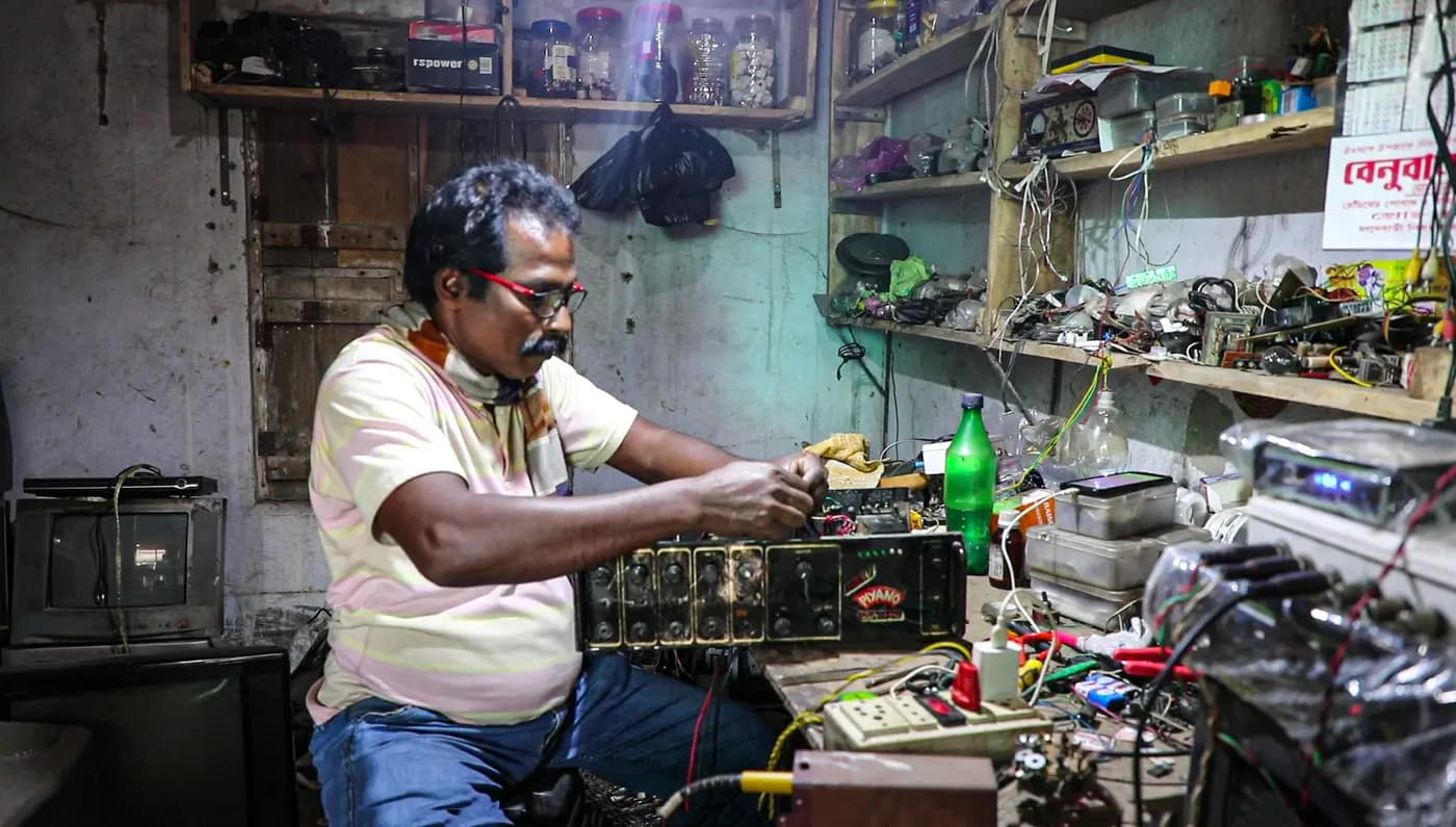 DJ box maker wiring an amplifier at his workbench