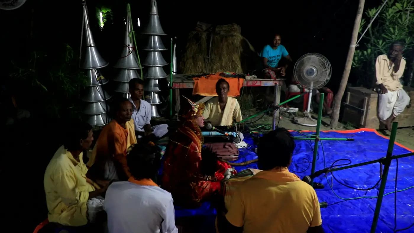 Night-time devotional music troupe under loudspeaker horns