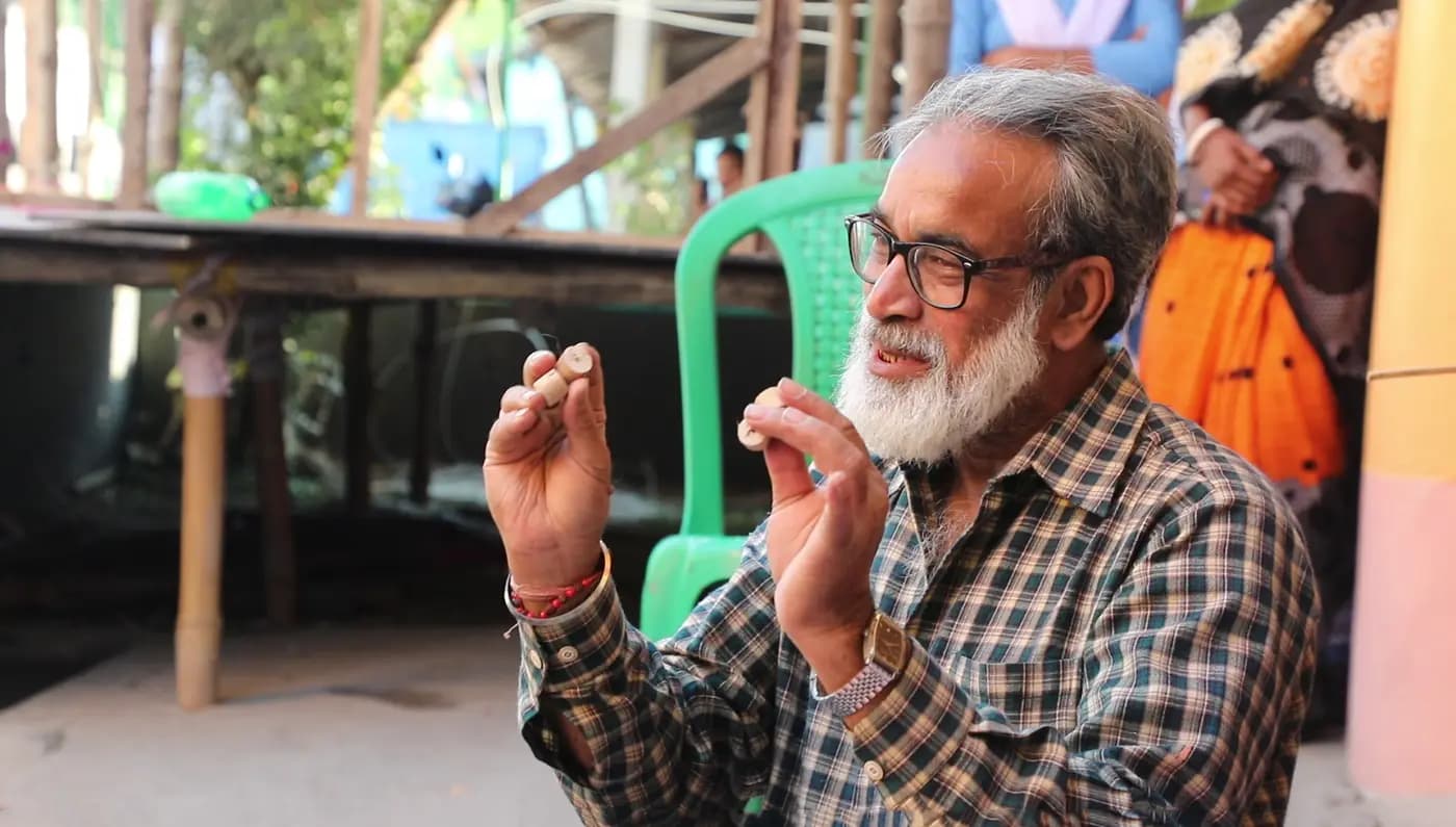 Portrait of artist Sudip Maiti explaining a craft