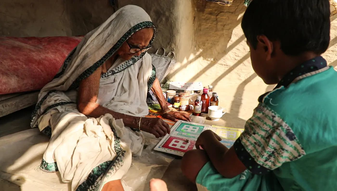 Gitarani Maity playing a board game with a boy