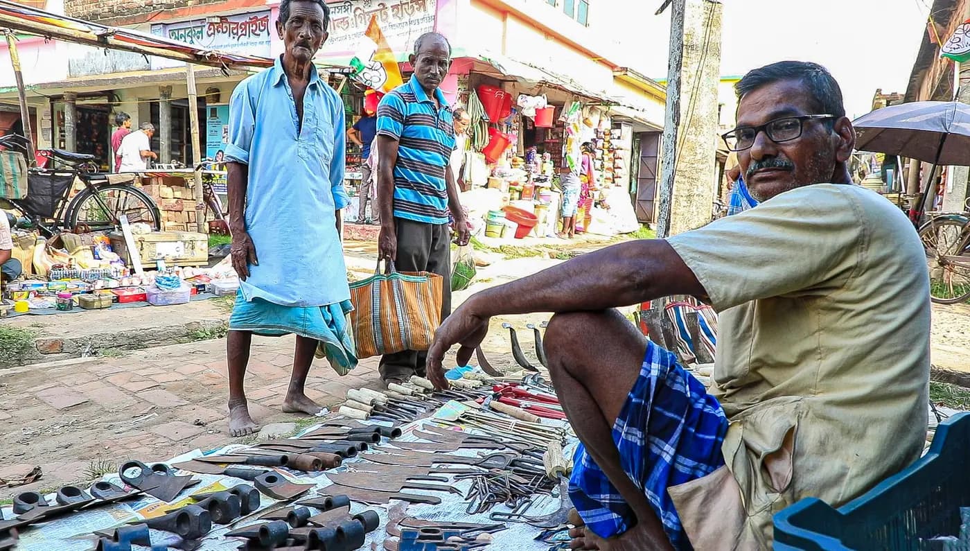 Tool seller with sickles and knives at the haat