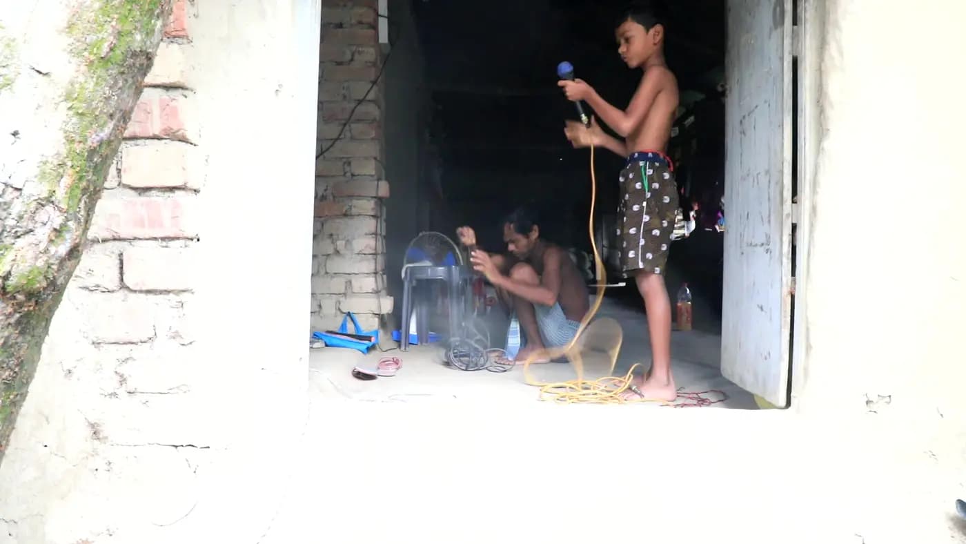 Boy setting up a microphone in a doorway