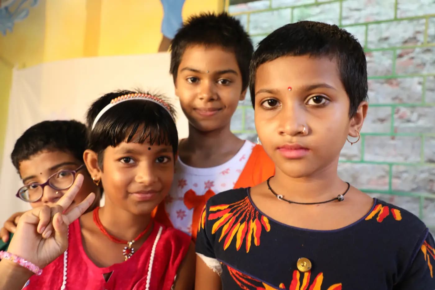 Four smiling village children