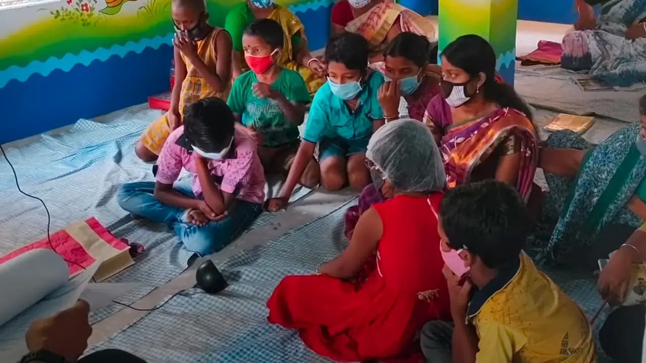 Children and teachers around a smart speaker