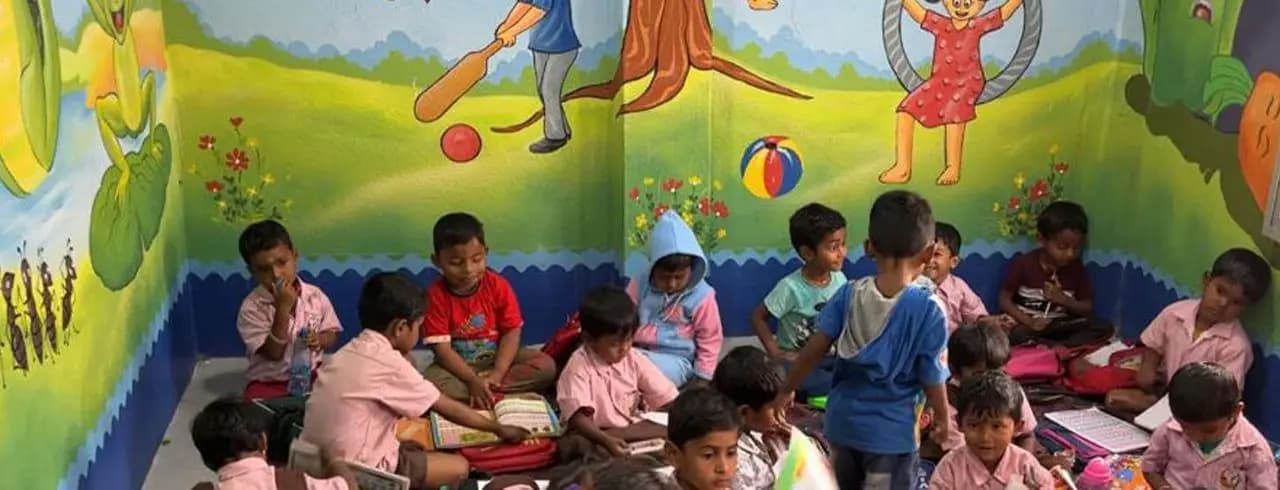 Nursery children in a classroom with painted murals