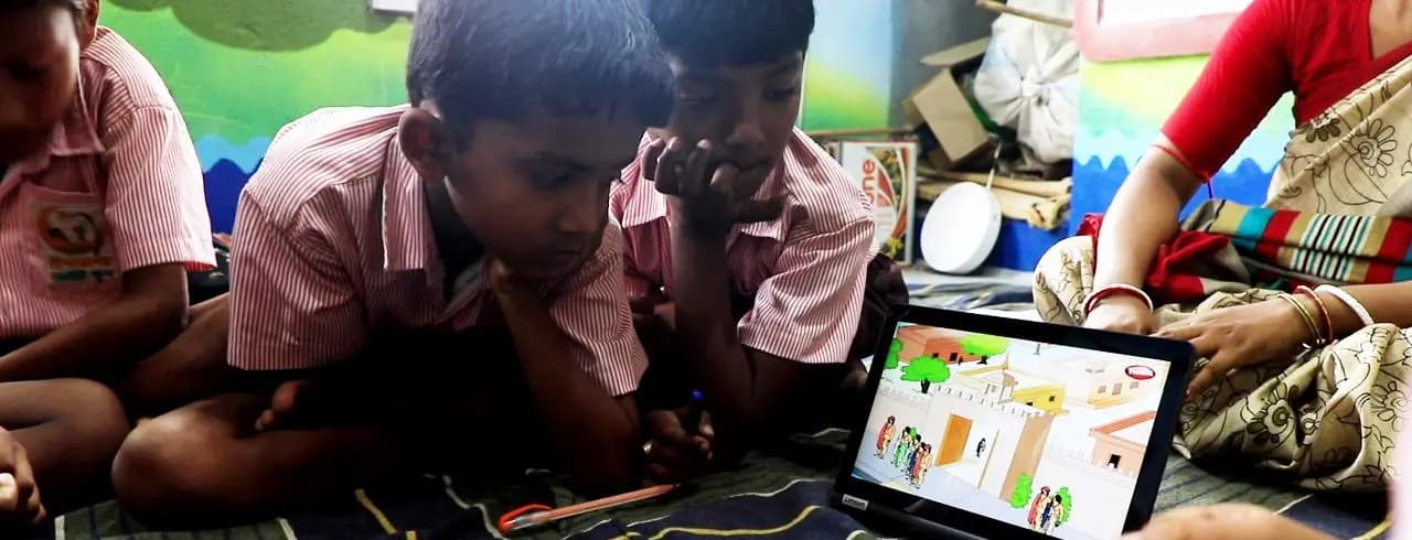 Nursery boys looking at a story on a tablet