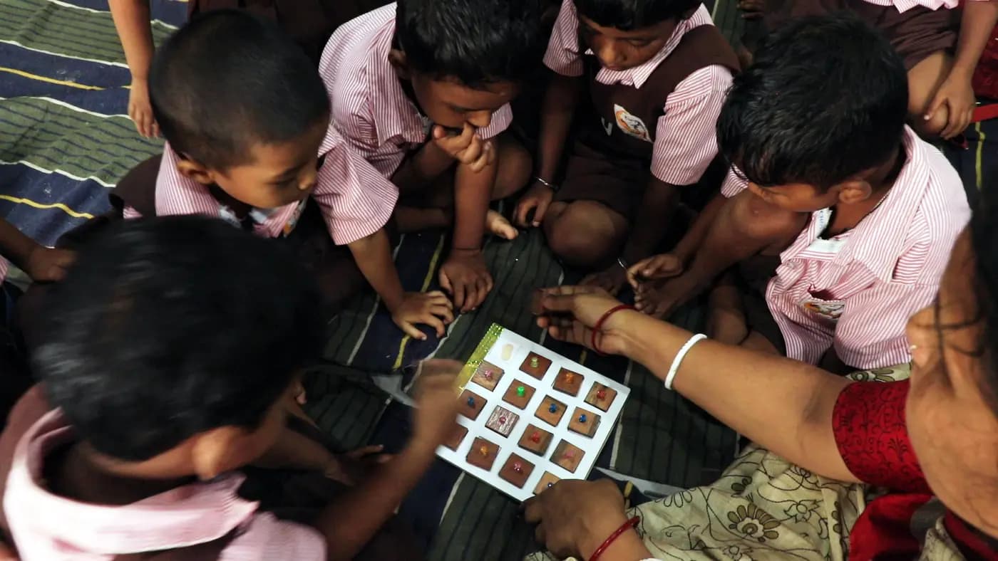Nursery boys using a matching board learning kit