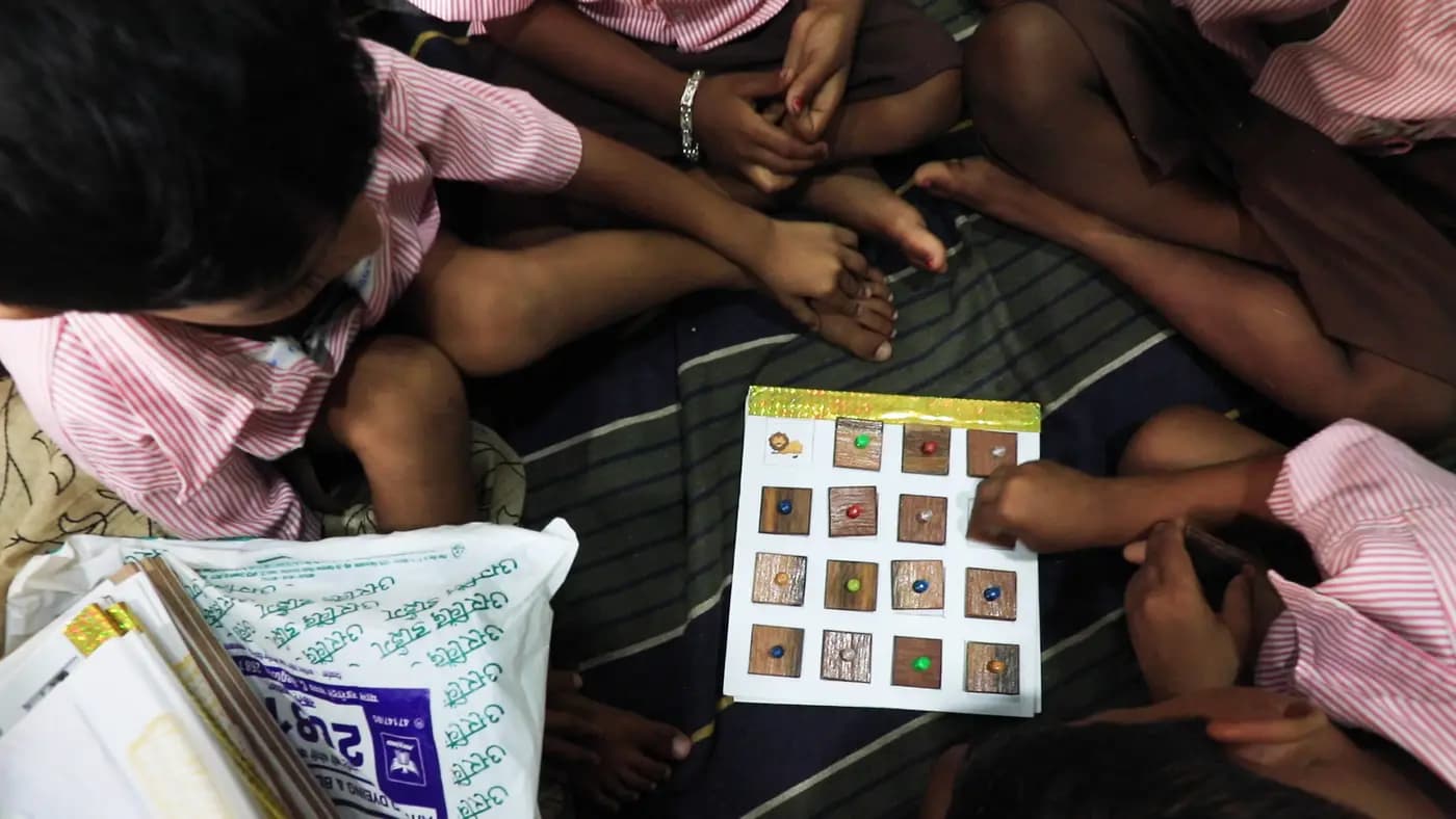 Children using a wooden matching board