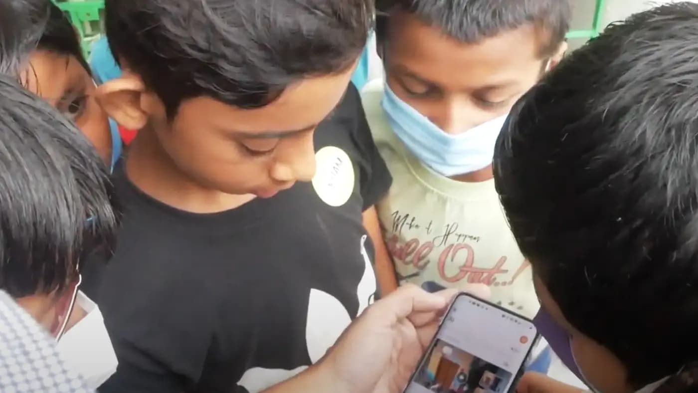 Boys looking at a phone together