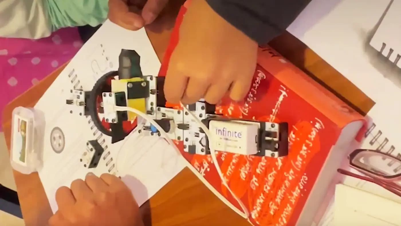 Hands assembling an electronics kit