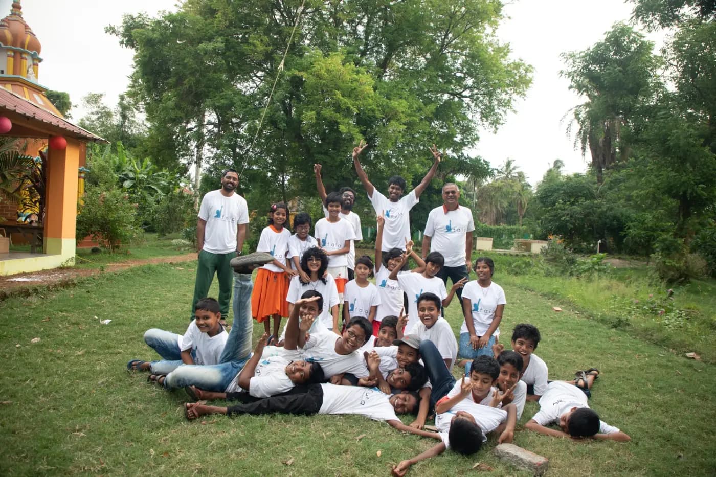 FALA children and facilitators posing on a lawn