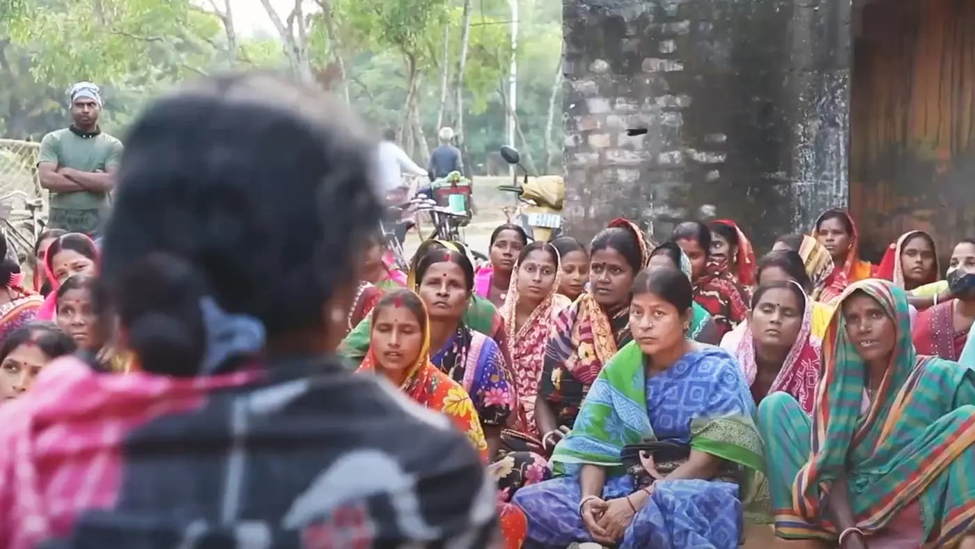 Village women gathered at an outdoor meeting