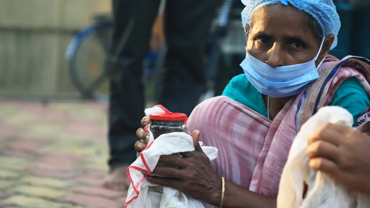 Older woman holding a jar of preserve