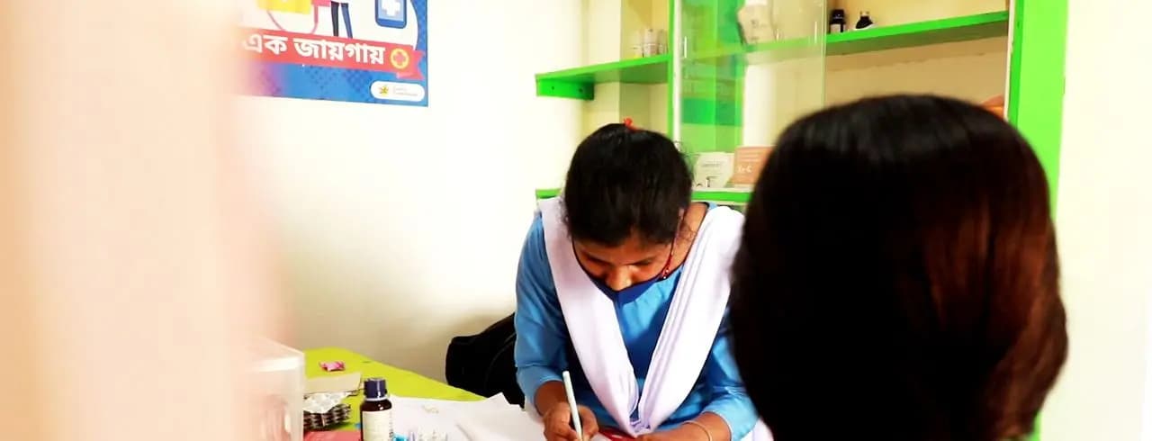 Paramedic writing notes for a patient at the Uday clinic