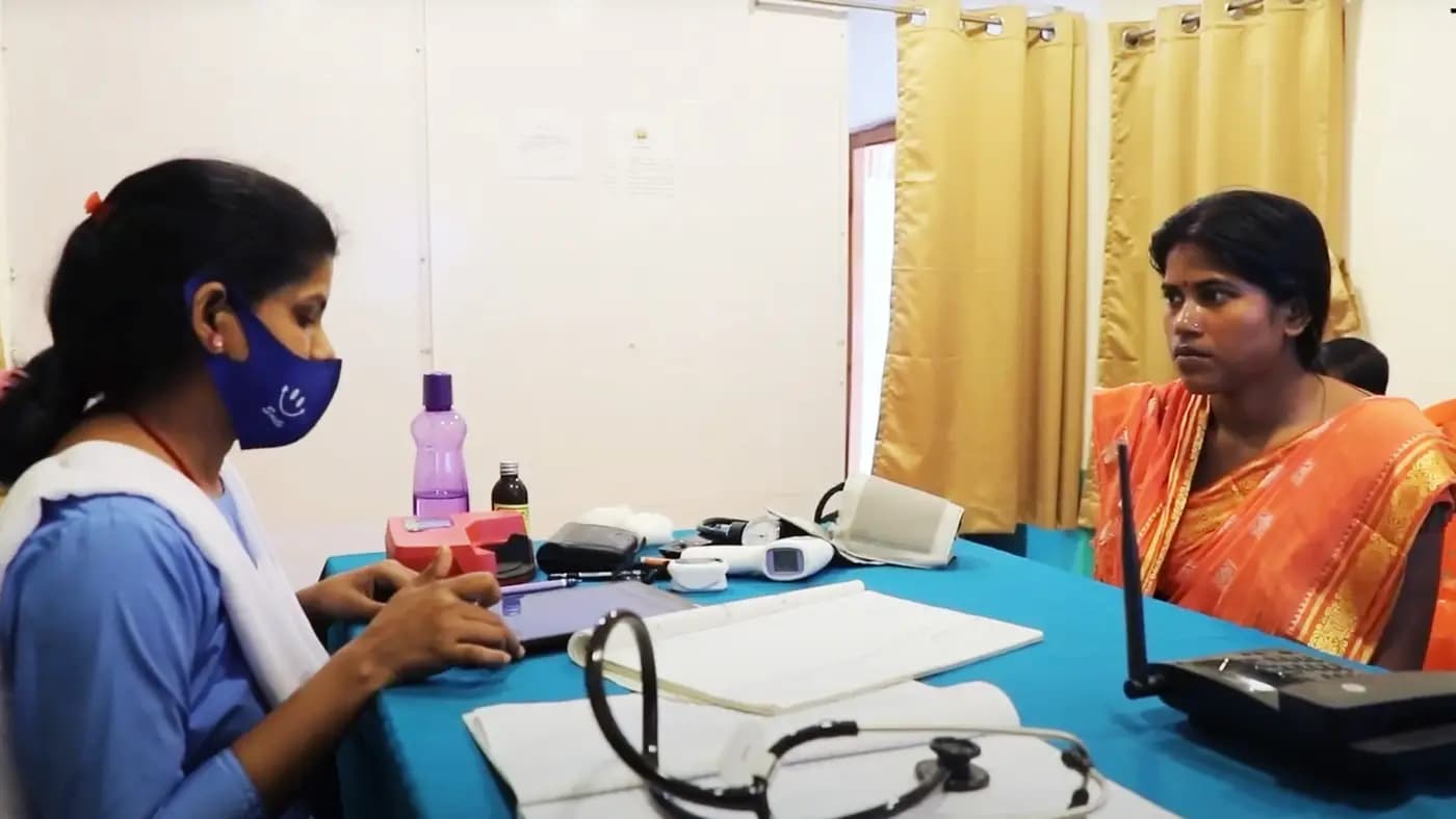 Health worker with a tablet attending a patient