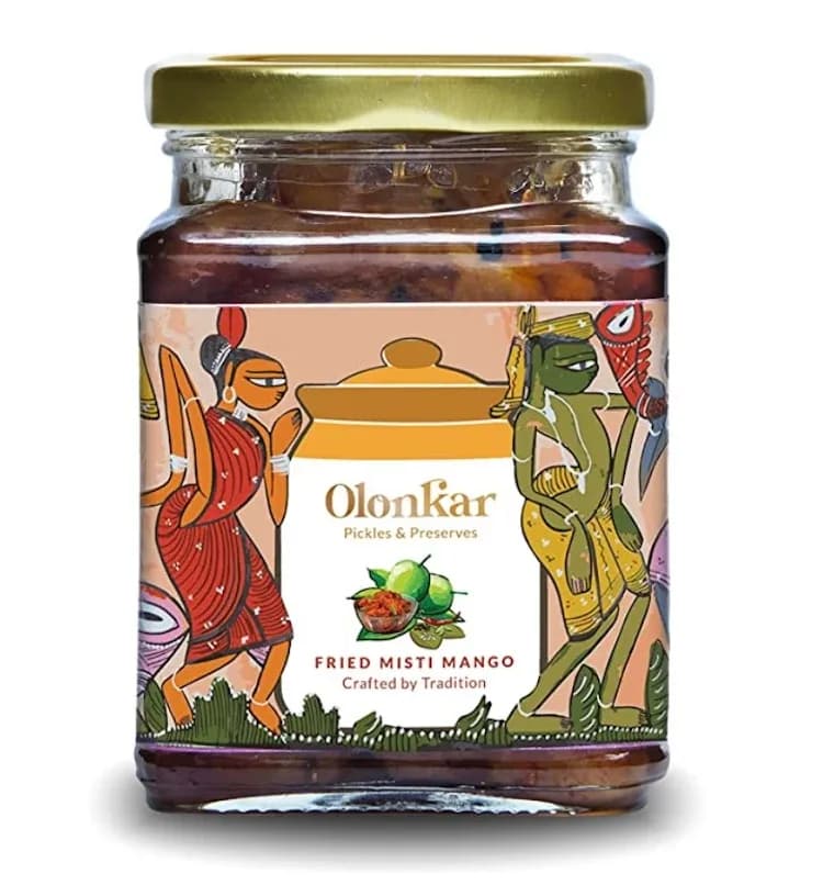 A jar of Fried Mishti Mango pickle with a gold lid and a Bengal folk-art label
