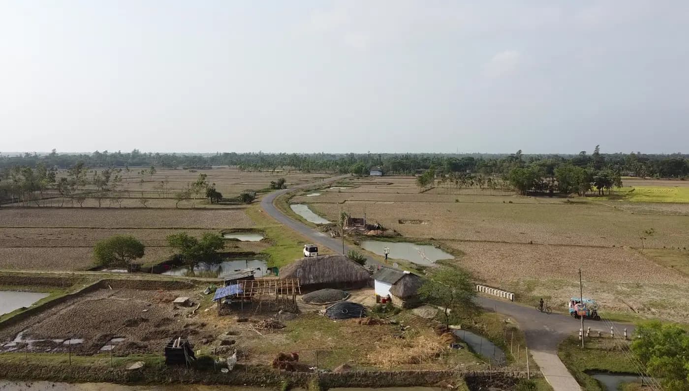 Aerial view of a farmstead and road through fields
